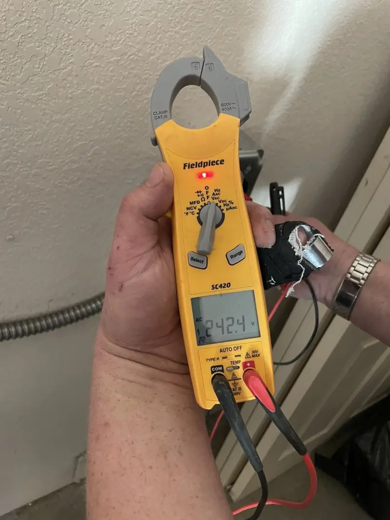 Voltage testing with clamp meter during Electrical Installation Services in Waller